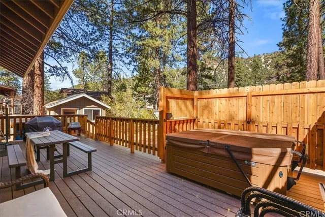 a view of a balcony with wooden floor and outdoor seating