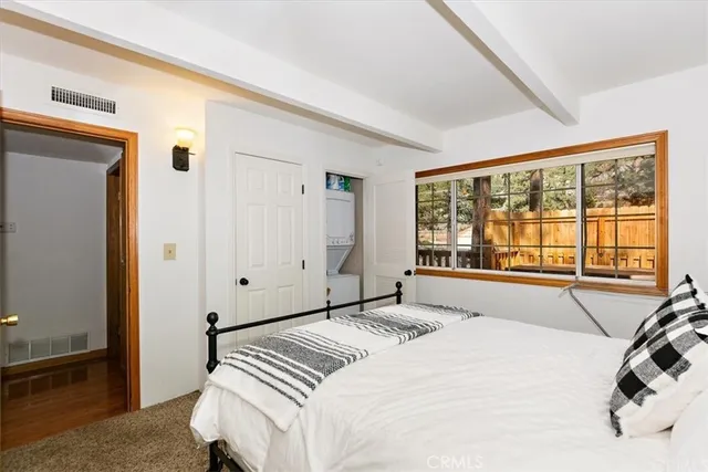 a bedroom with a bed and a large window