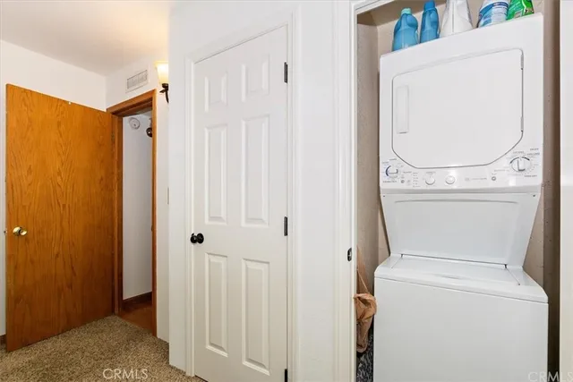 a view of a storage & utility room with dryer and washer