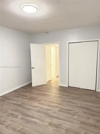an empty room with wooden floor