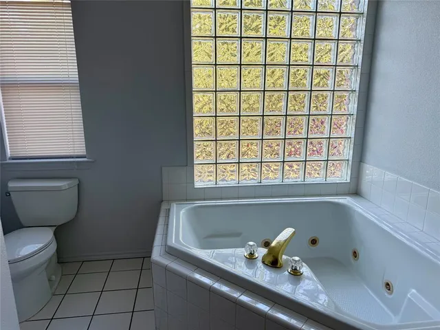 a bathroom with a bathtub and window