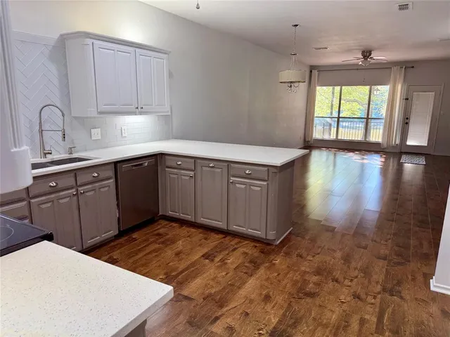 a kitchen with stainless steel appliances granite countertop a sink stove and cabinets