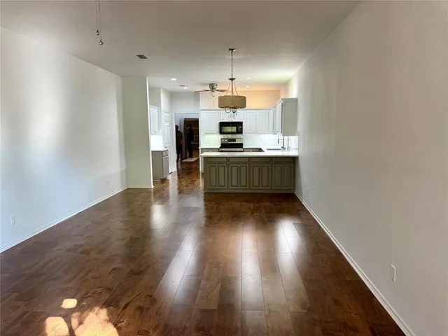 a kitchen with kitchen island a sink stainless steel appliances and cabinets