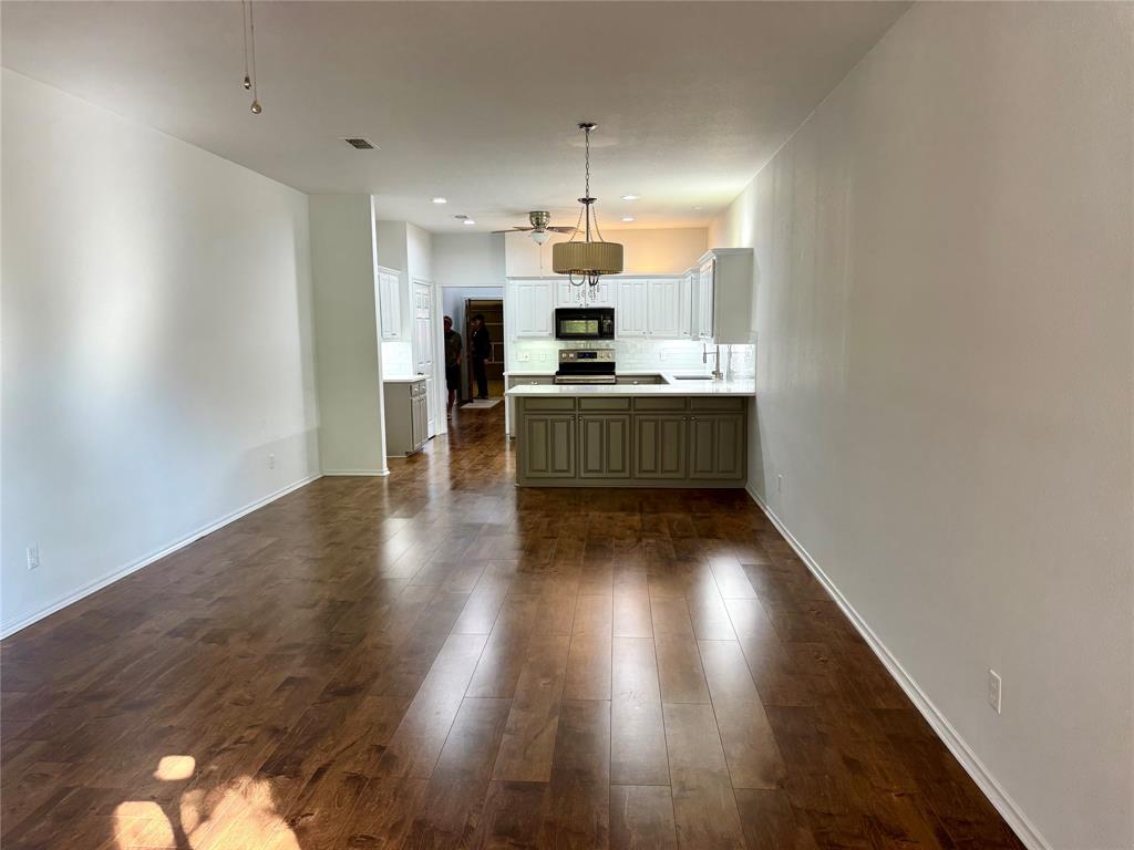 2116 Clear Lake Road Weatherford, TX 76087 - Photo 6 of 21 a kitchen with kitchen island a sink stainless steel appliances and cabinets