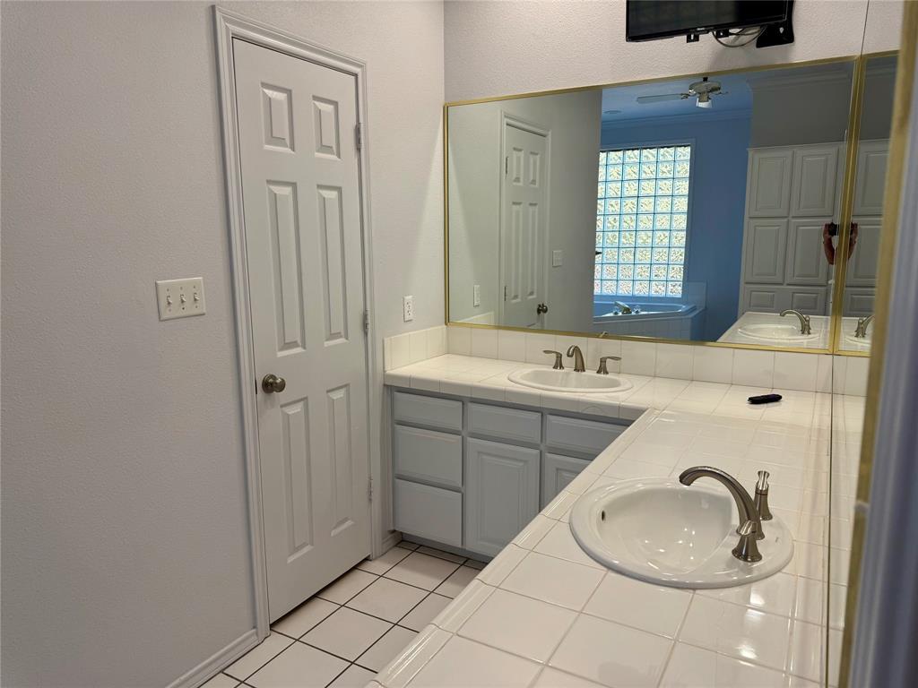 2116 Clear Lake Road Weatherford, TX 76087 - Photo 10 of 21 a bathroom with a sink and a mirror
