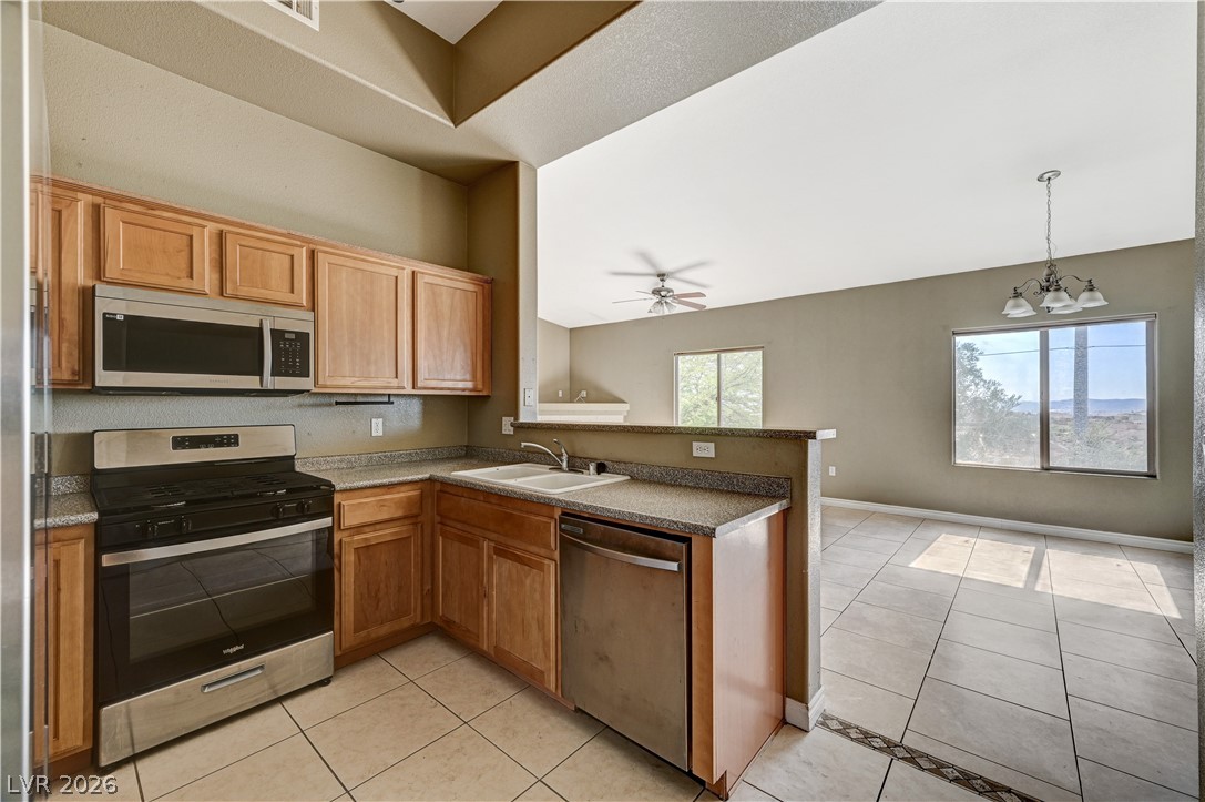 8985 South Durango Drive, Unit 2187 Las Vegas, NV 89113 - Photo 13 of 73 A well-appointed kitchen boasts sleek stainless steel appliances and durable tile flooring.