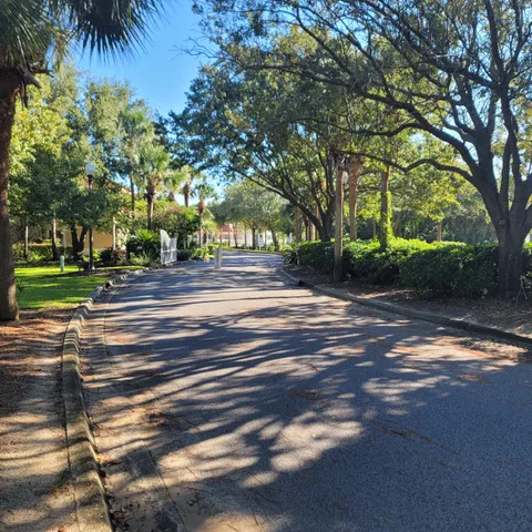 a view of a street with a house and trees