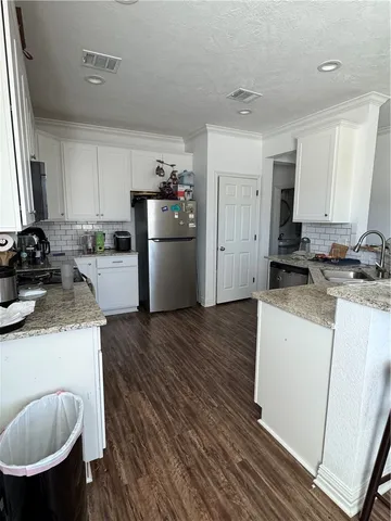 a kitchen with a sink and a stove top oven