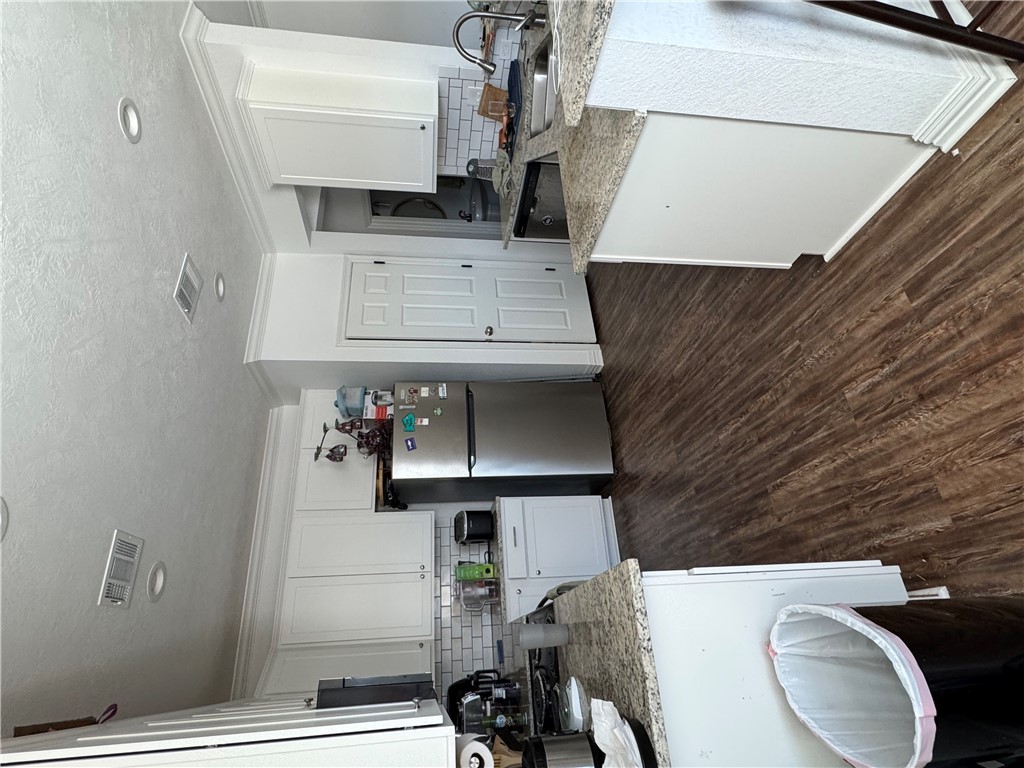 6991 Halter Loop College Station, TX 77845 - Photo 2 of 8 a kitchen with a sink and a stove top oven