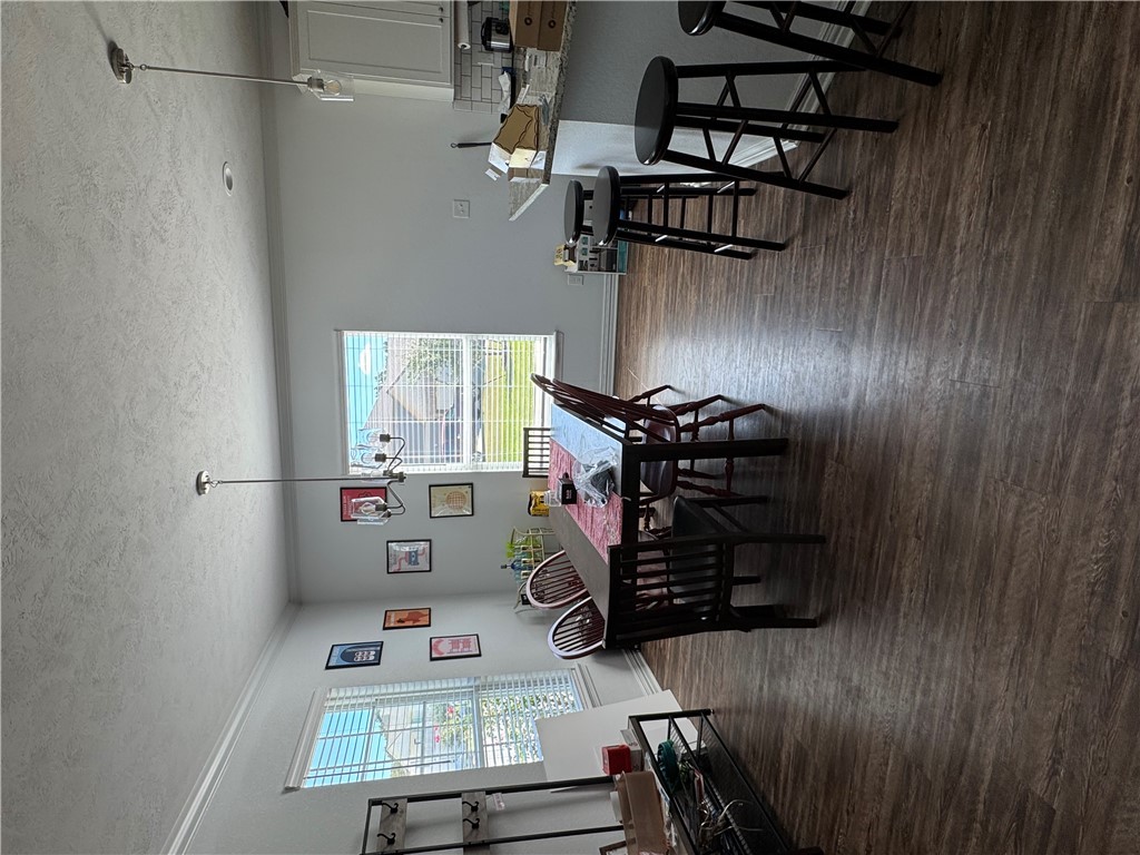 6991 Halter Loop College Station, TX 77845 - Photo 3 of 8 a view of a dining room with furniture window and wooden floor