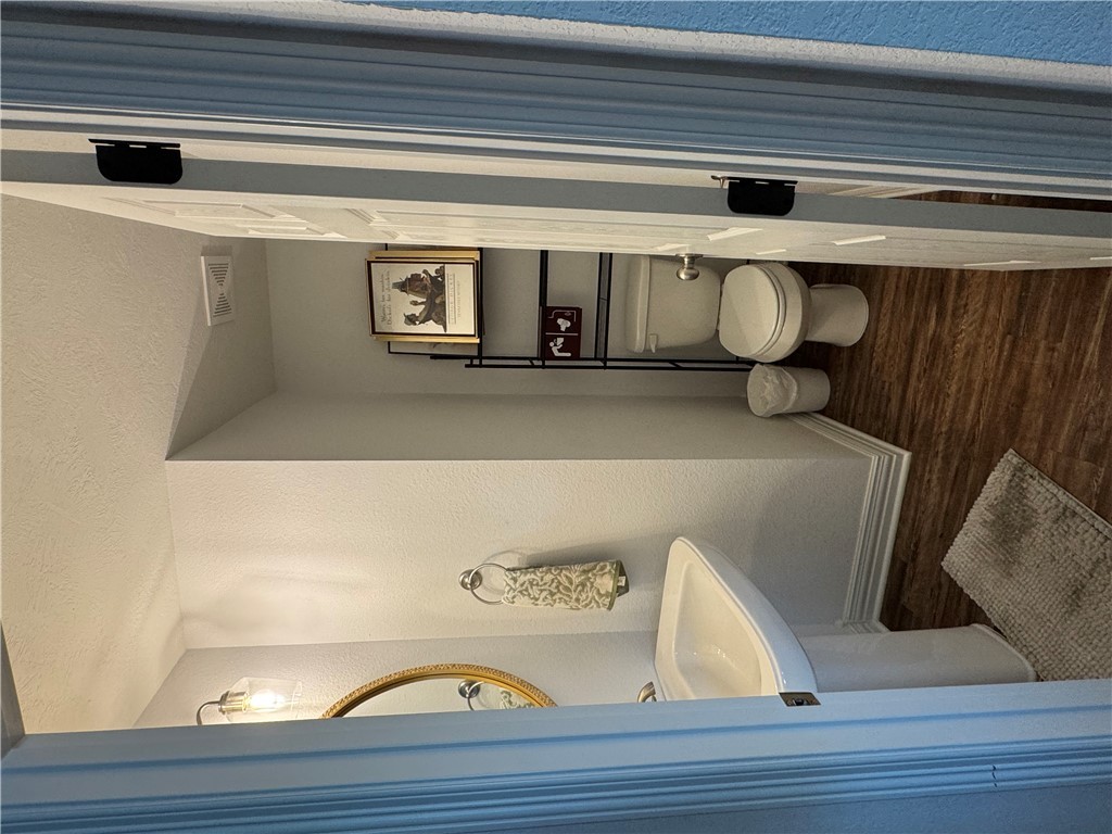 6991 Halter Loop College Station, TX 77845 - Photo 4 of 8 a bathroom with a toilet a sink and mirror