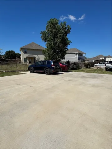a front view of a house with cars parked