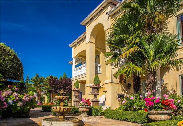 a front view of multi story residential apartment building with yard