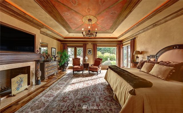 a large white kitchen with wooden floor and a sink