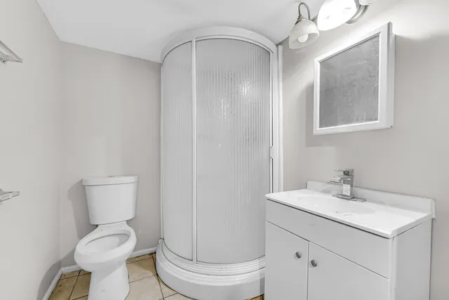 a bathroom with a toilet sink and a mirror