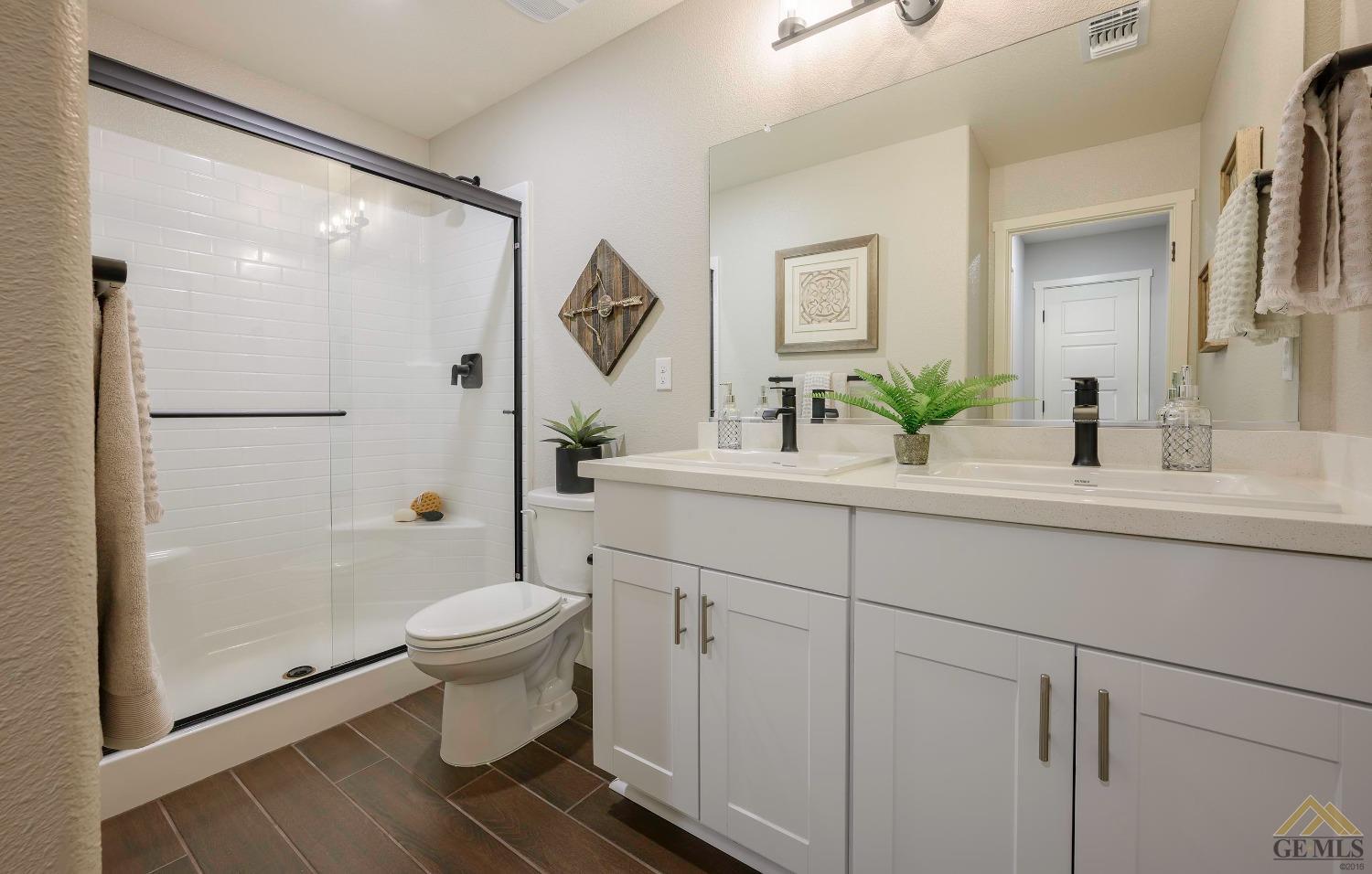 Undisclosed Address Bakersfield, CA 93311 - Photo 11 of 19 a bathroom with a sink toilet and shower