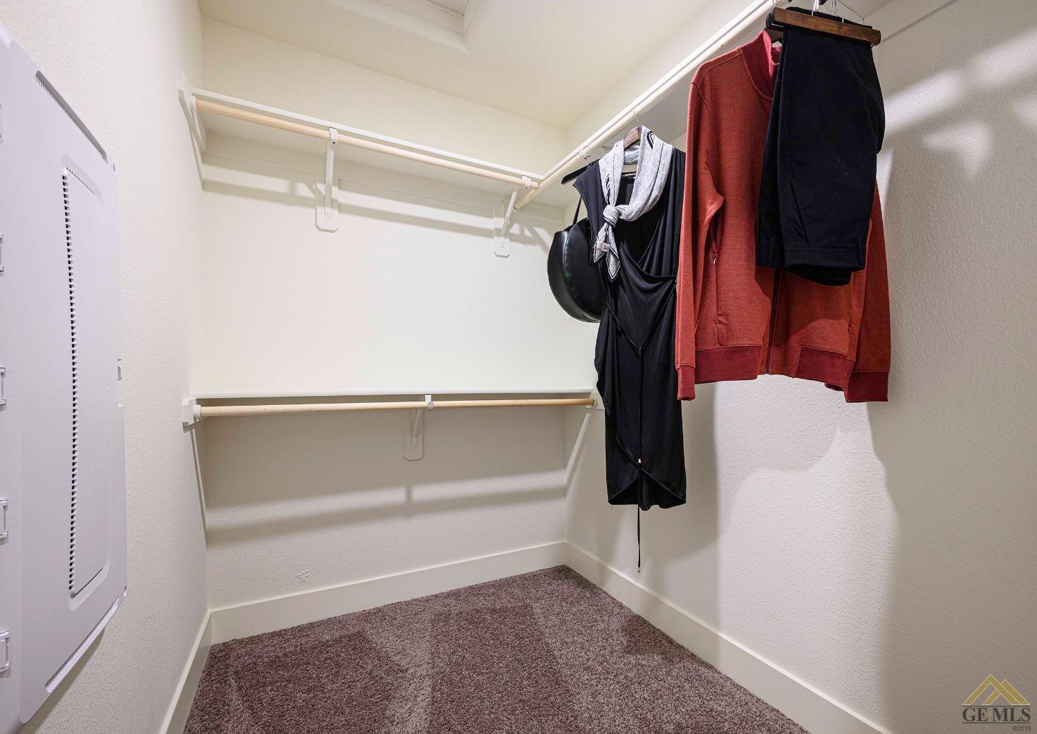 Undisclosed Address Bakersfield, CA 93311 - Photo 12 of 19 a view of walk in closet with clothes and shoes