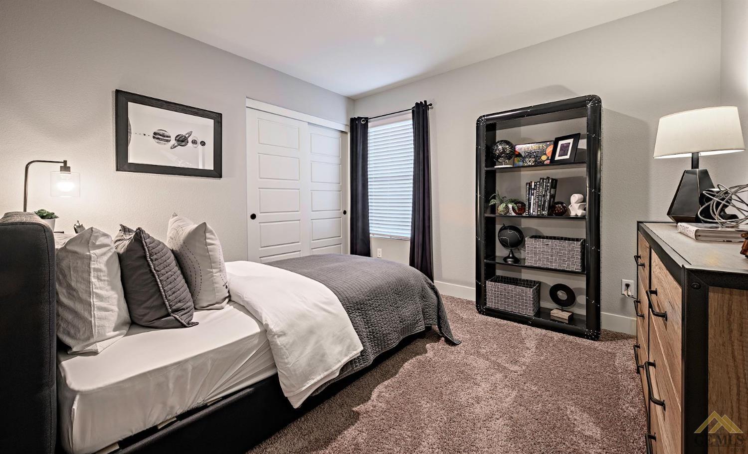 Undisclosed Address Bakersfield, CA 93311 - Photo 17 of 19 a bedroom with bed and a book shelf