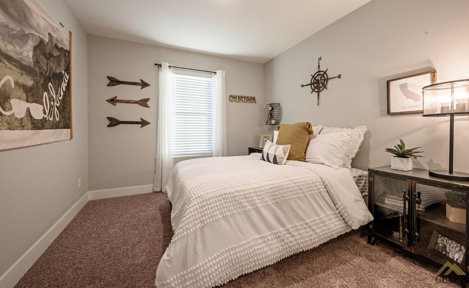 Undisclosed Address Bakersfield, CA 93311 - Photo 18 of 19 a bedroom with a bed and a table in it