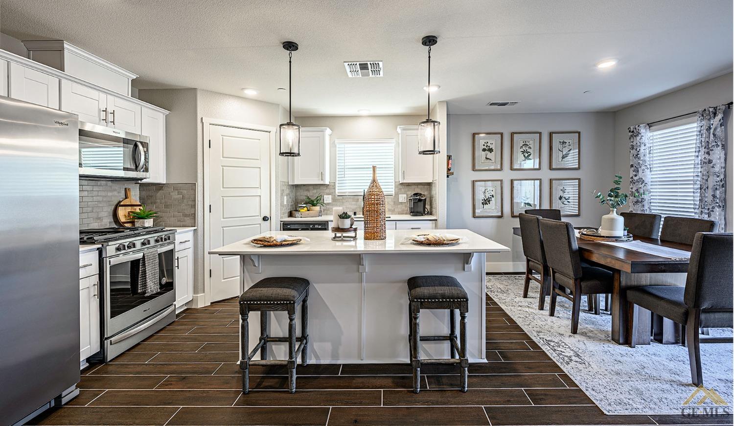 Undisclosed Address Bakersfield, CA 93311 - Photo 3 of 19 a kitchen with stainless steel appliances granite countertop a table chairs stove a sink dishwasher and a refrigerator