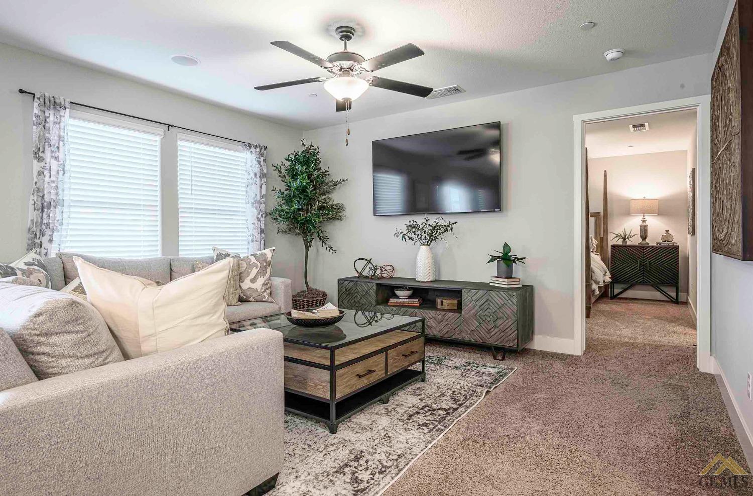 Undisclosed Address Bakersfield, CA 93311 - Photo 8 of 19 a living room with furniture and a flat screen tv