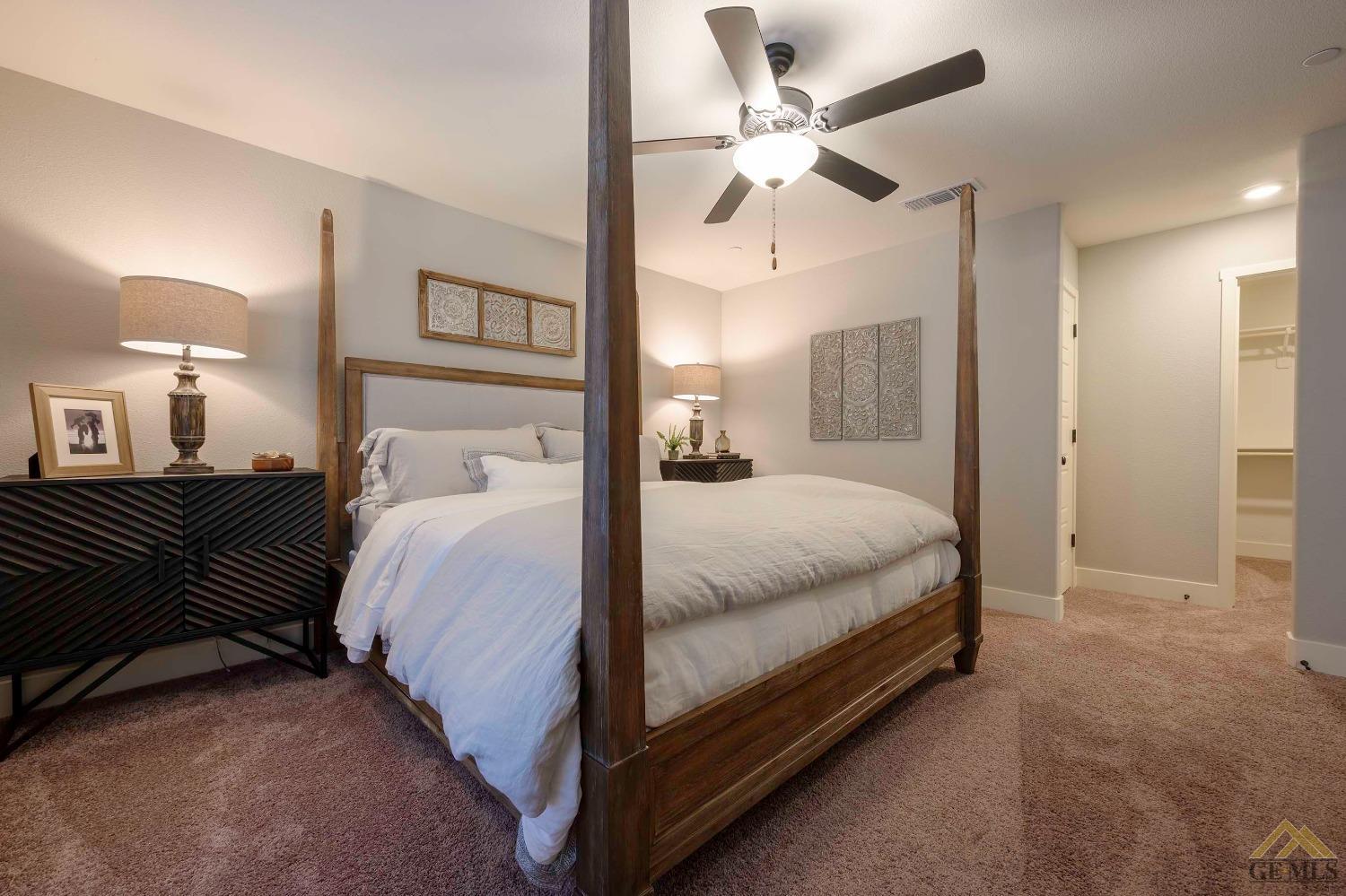 Undisclosed Address Bakersfield, CA 93311 - Photo 9 of 19 a large bed sitting in a bedroom and a chandelier