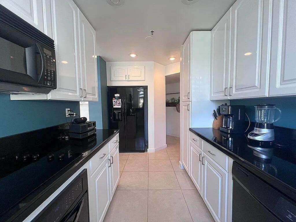 6463 La Costa Drive, Unit 105 Boca Raton, FL 33433 - Photo 5 of 40 a kitchen with granite countertop stainless steel appliances and cabinets