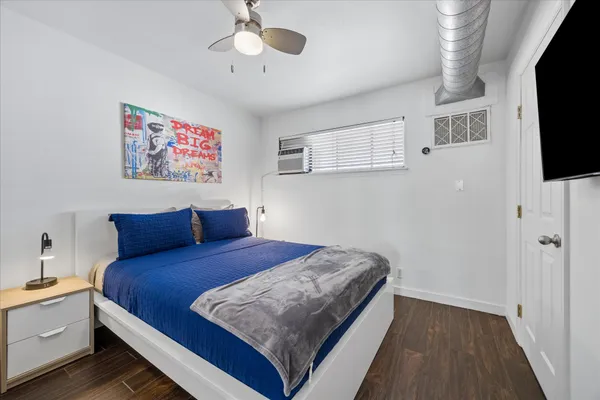 a bedroom with a bed and a flat screen tv