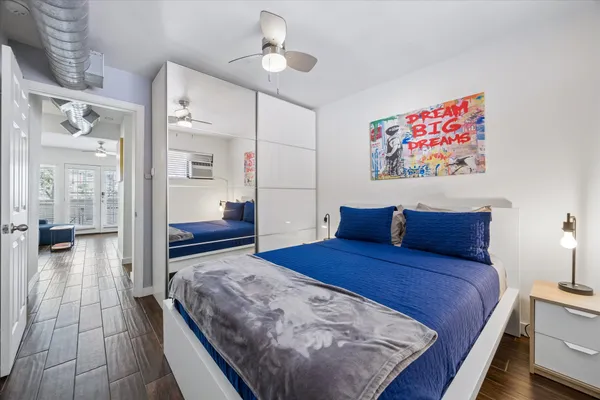 a bedroom with a large bed and a chandelier