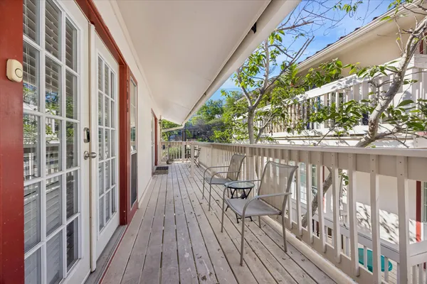 a house view with a swimming pool and porch