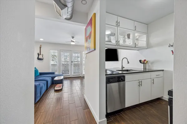 a kitchen with stainless steel appliances granite countertop a sink and cabinets