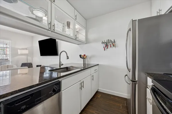 a kitchen with stainless steel appliances a sink and cabinets