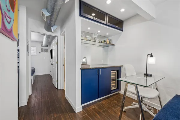 a view of a hallway with furniture and wooden floor