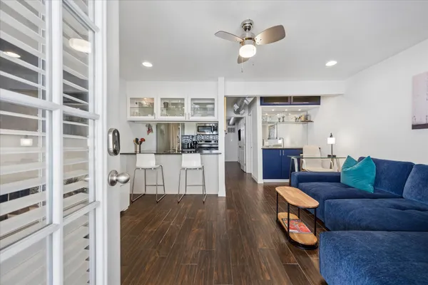 a living room with furniture and wooden floor