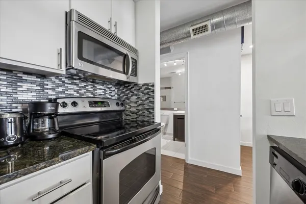 a kitchen with wooden cabinets and stainless steel appliances