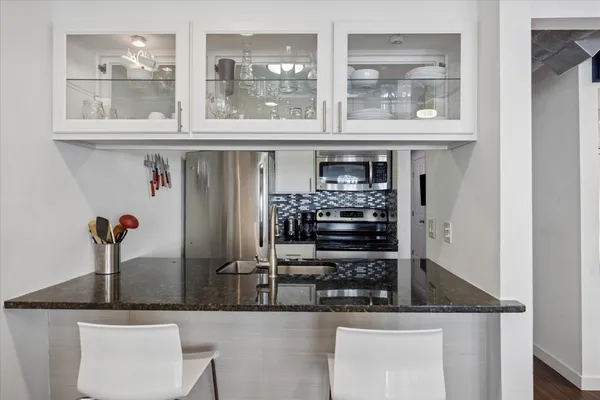 a kitchen with a refrigerator and window