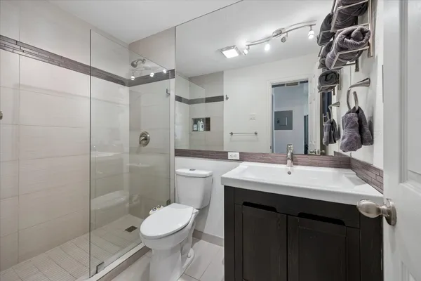 a bathroom with a sink toilet and shower