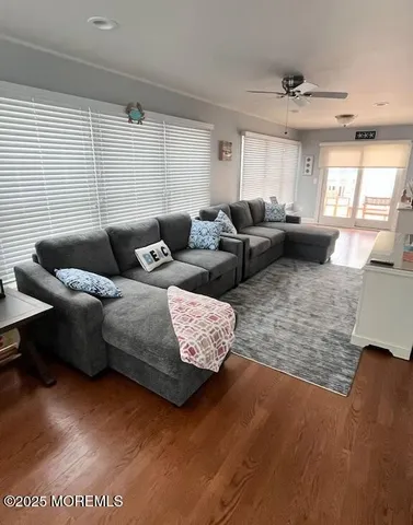 a living room with furniture wooden floor and window