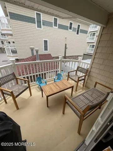 a balcony with a couch and chairs
