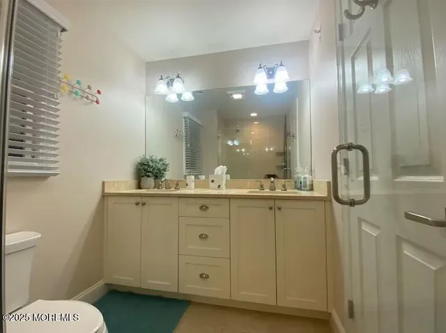 a bathroom with a double vanity sink and a mirror