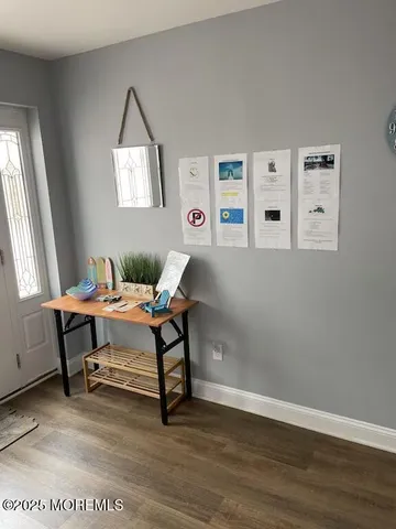 a view of a workspace with furniture and a window