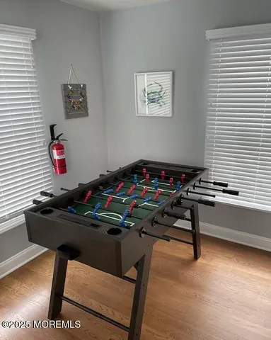 a room with furniture pool table and a window