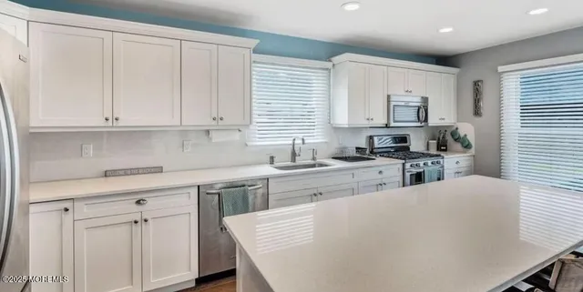 a kitchen with cabinets appliances and a window