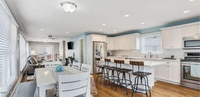 a large kitchen with a table and chairs