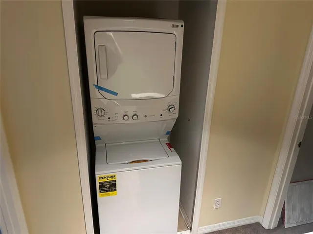 an empty room with closet and windows