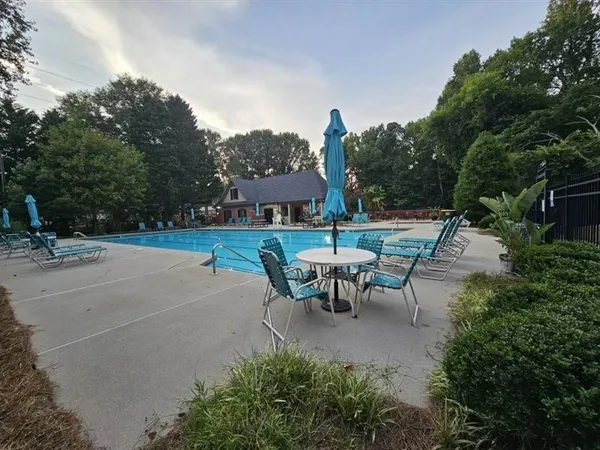 a view of a patio with table and chairs under an umbrella