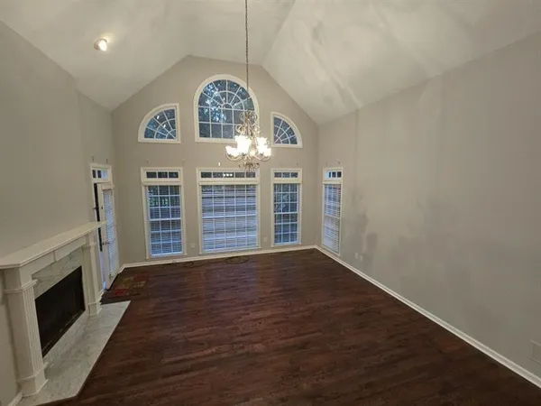 wooden floor in an empty room with a fireplace