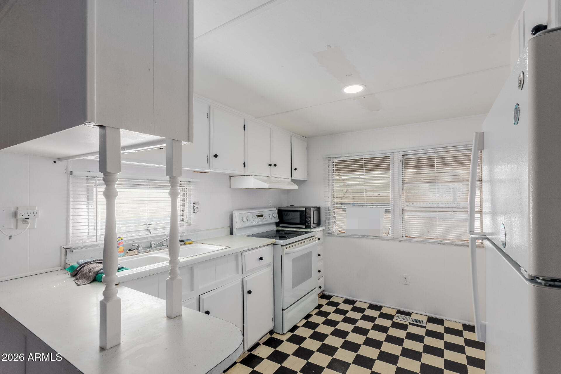 2434 East Main Street, Unit 123 Mesa, AZ 85213 - Photo 12 of 29 a kitchen with a sink a stove and cabinets