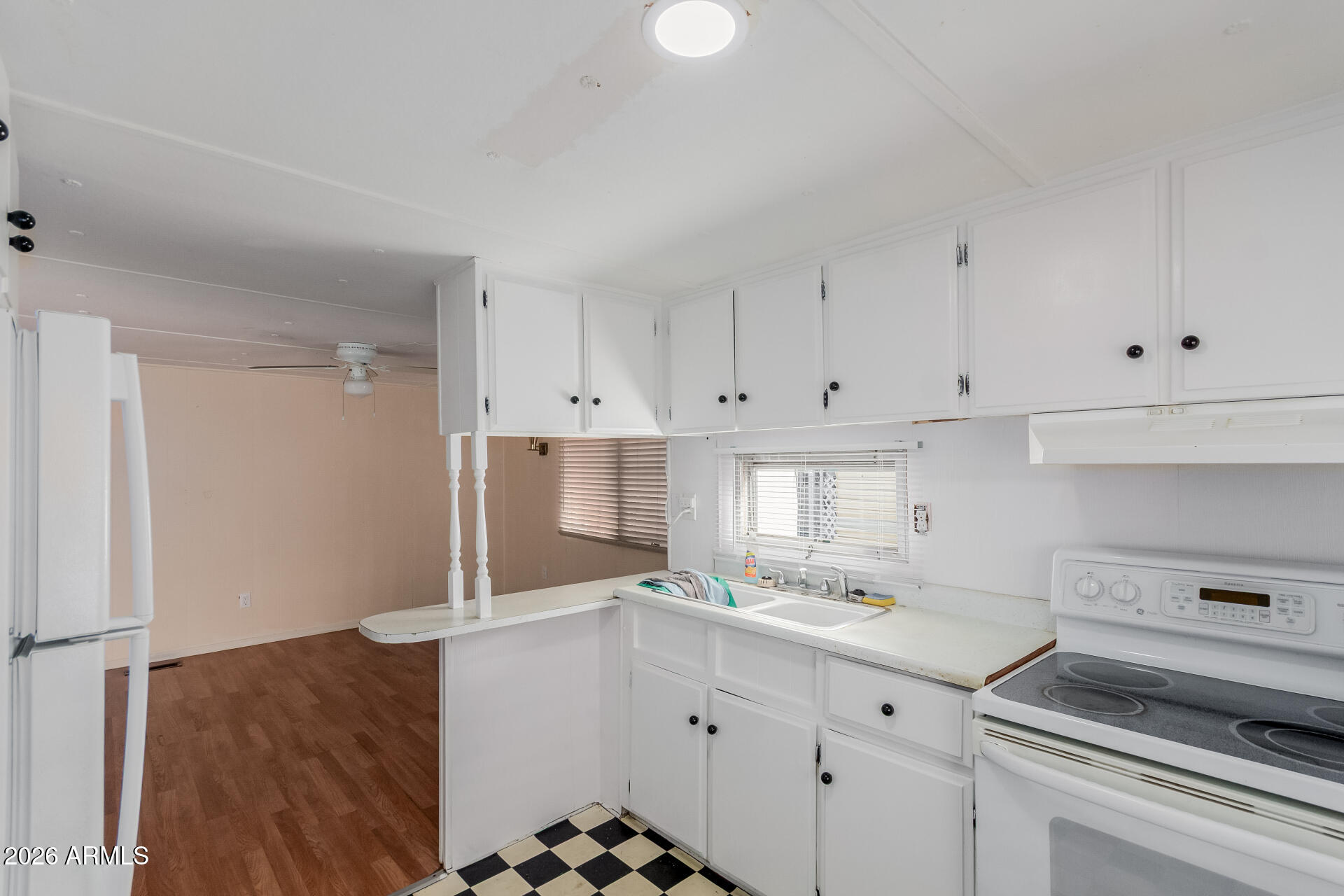 2434 East Main Street, Unit 123 Mesa, AZ 85213 - Photo 15 of 29 a kitchen with granite countertop white cabinets and white appliances