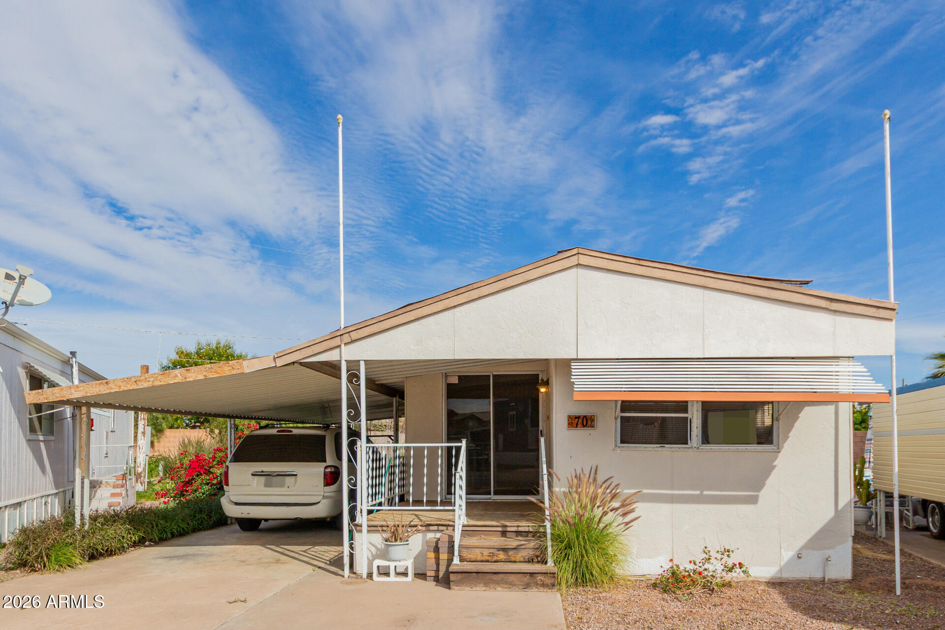 2434 East Main Street, Unit 123 Mesa, AZ 85213 - Photo 2 of 29 a front view of a house with a porch